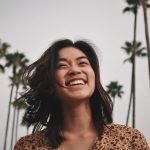 asian woman smiling palm trees